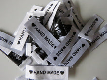 Load image into Gallery viewer, 25 White Labels printed with &quot;Hand Made&quot; between Black Hearts Labels 50 x 15mm