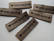 Load image into Gallery viewer, 8 Tan Brown &quot;Hand Made&quot; between 2 Brown Hearts Labels 50mm x 15mm