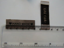 Load image into Gallery viewer, 50 Tan Brown &quot;Hand Made&quot; between 2 Brown Hearts Labels 50mm x 15mm