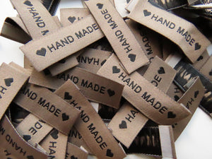 25 Tan Brown "Hand Made" between 2 Brown Hearts Labels 50mm x 15mm