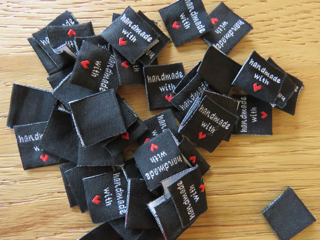 10 Black Handmade with red heart 2 x 2cm satin flag labels.