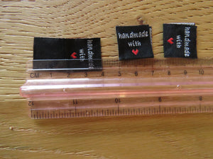 10 Black Handmade with red heart 2 x 2cm satin flag labels.